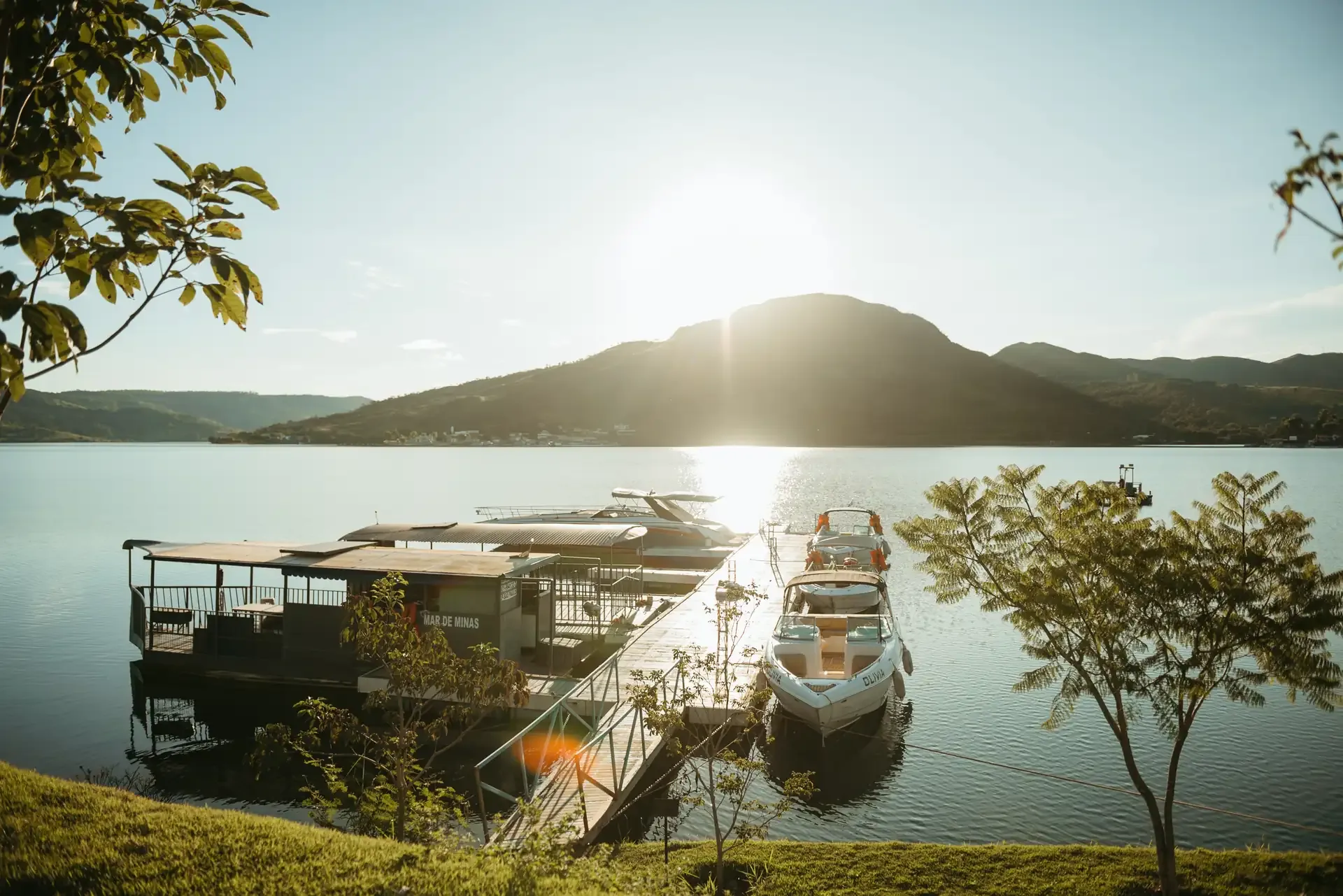 Píer com lanchas no Lago de Furnas ao pôr do sol